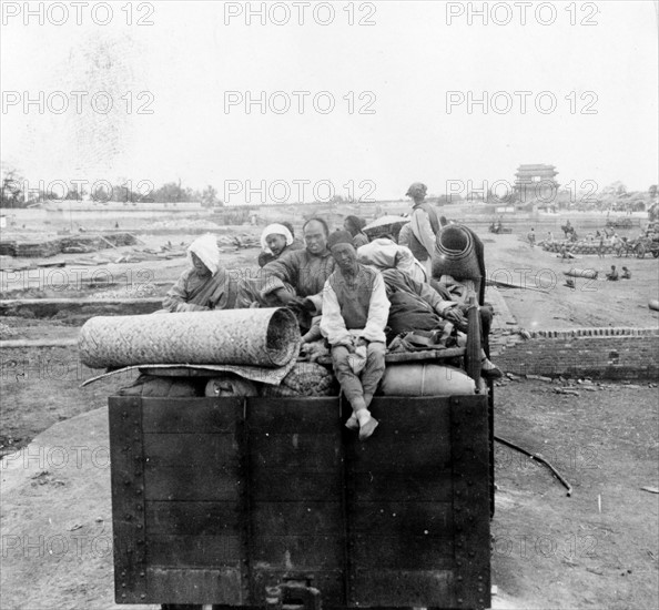 Chinese Christians sitting on their belongs