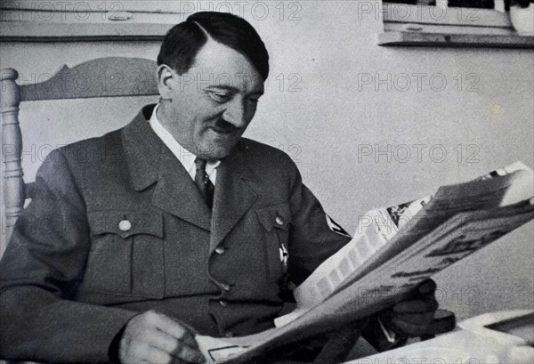 Adolf Hitler reading a newspaper