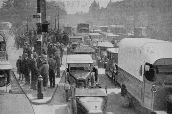 London traffic crowds the roads of the British capital during the nineteen twenties.