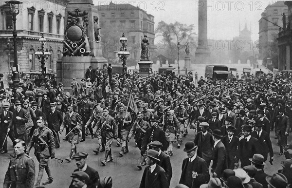 British soldiers parade through a London street during WWI.