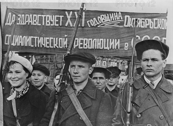 Factory workers drilling with guns