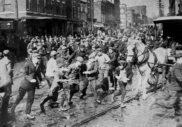 Rioters charging across a street