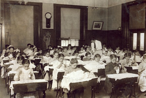 American school teaching girls how to sew