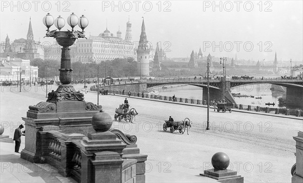 Photograph of horse-drawn wagons and motor trucks