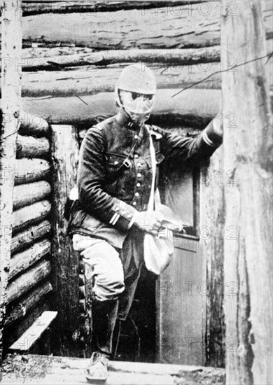 French soldier emerges in gas mask from a trench during WWI