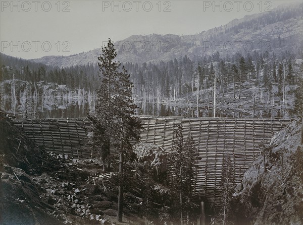 Male figure sitting on top of a water dam