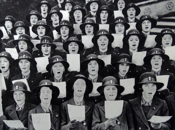 Dutch girl guides sing as a choir;