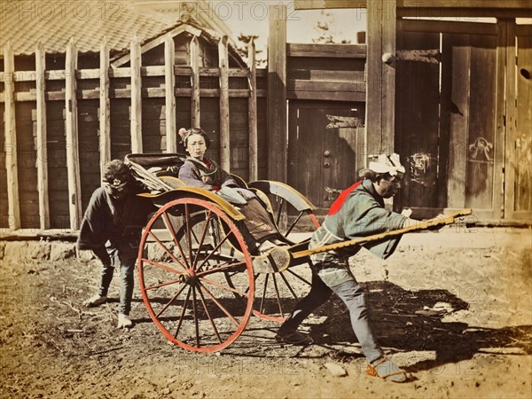 Colour photograph of Japanese women in a rickshaw, with two drivers