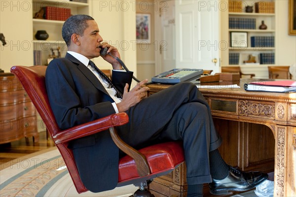 Barak Obama on the phone in the Oval Office with Rene Preval.