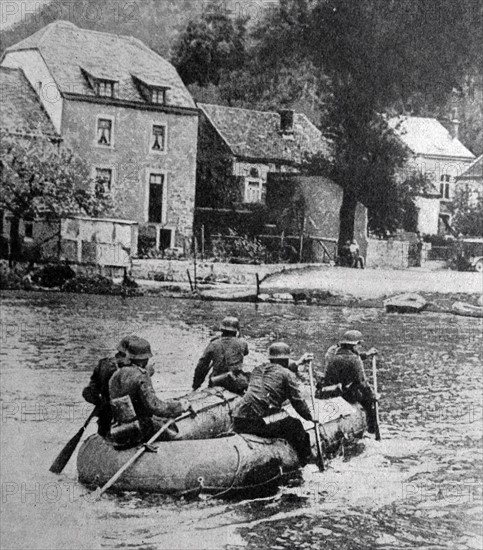 Photograph of Nazis paddling a rubber boat across a river in Belgium