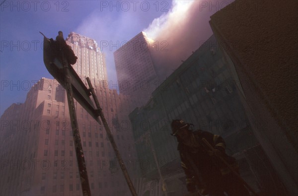 Colour photograph of a New York Fire-fighter amid the rubble of the World Trade Centre following the 9/11 attacks