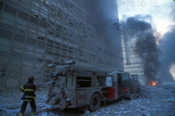 Colour photograph of a New York Fire-fighter amid the rubble of the World Trade Centre following the 9/11 attacks