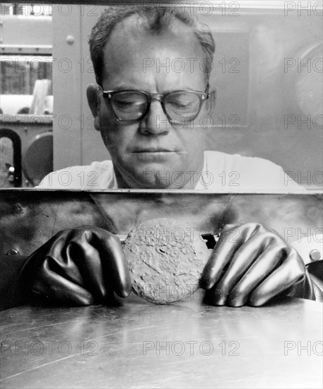 Photograph of a worker handling Plutonium