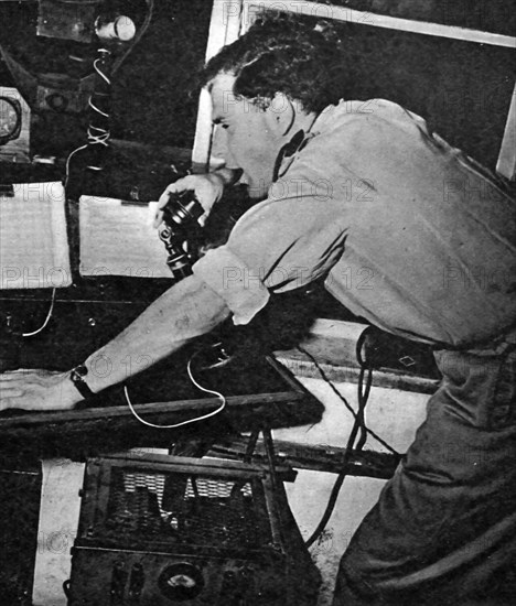 Photograph of a technician aiding aircrafts over the radio at Lydda Airport