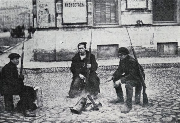 Photograph of soldiers sitting with their guns in the street during the February Revolution of 1917