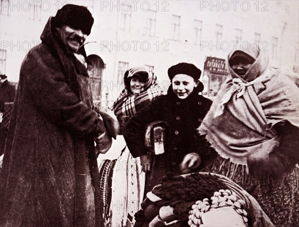 Photograph of a hawker of gloves, mittens and other woollens in Moscow