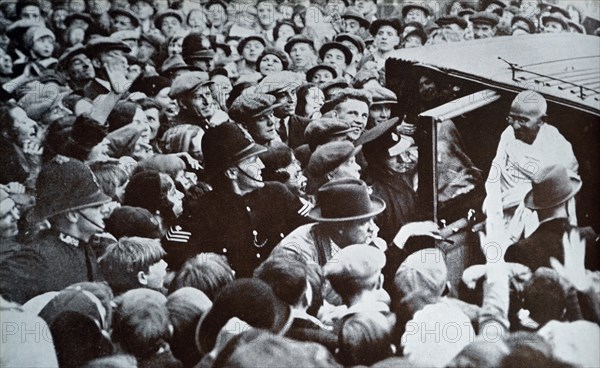Mahatma Gandhi greeted by well wishers as he arrives in London in 1931, during his tour of England
