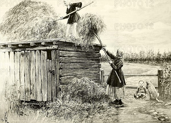 A peasant family storing winter fodder in the roof of a shed in Siberia, Russia