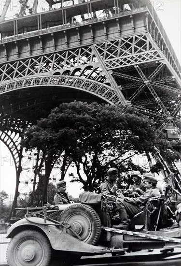 World War Two: German soldiers sit in a vehicle under the Eiffel Tower as they occupy Paris, during the invasion of France 1940