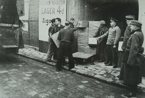Photograph of supplies being loaded into a German Army store in Paris, during the Invasion of France in 1940 in World War Two