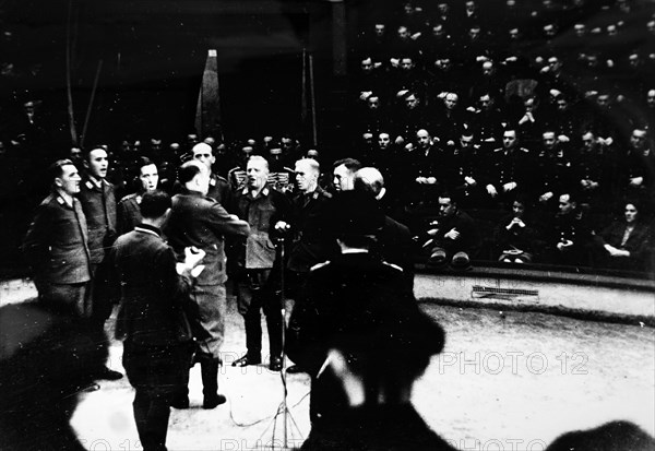 Photograph of Nazi soldiers singing at the start of a circus in Paris, during the German occupation of France, in World War Two