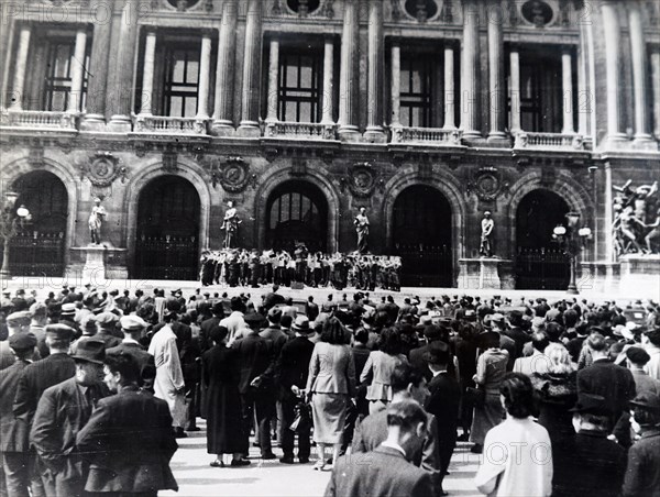 Photograph of Nazi soldiers singing in front of a Church in Paris, during the German occupation of France, in World War Two