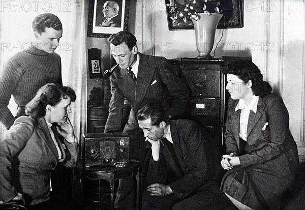 Vichy French civilians listening to a radio