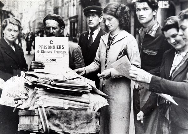 Photograph of the lists of prisoners of war being distributed in Paris , after the invasion of France in World War Two
