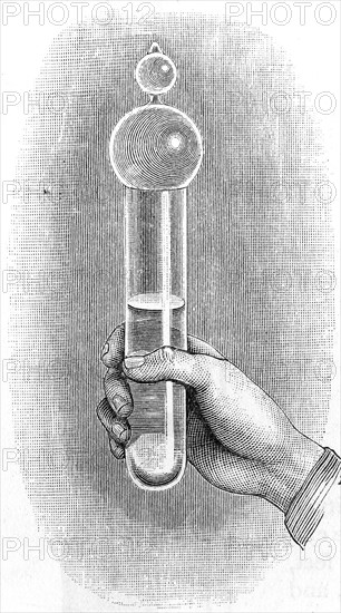 A water hammer: thick glass tube half filled with water and with air exhausted