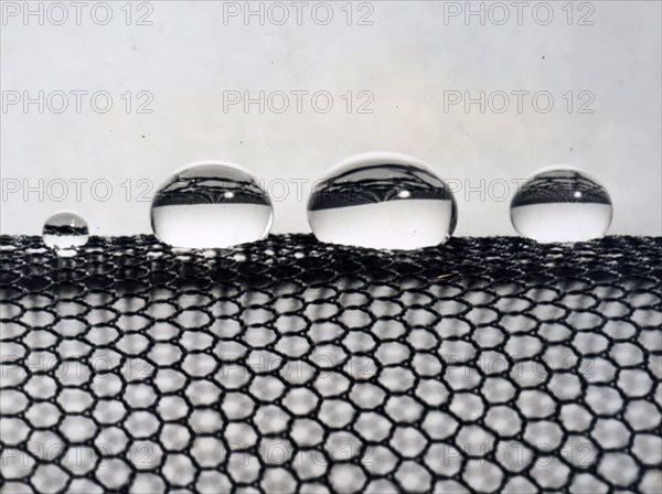 Photograph of water droplets resting on the wide meshes of DRIL-SIL silicone finished nylon net