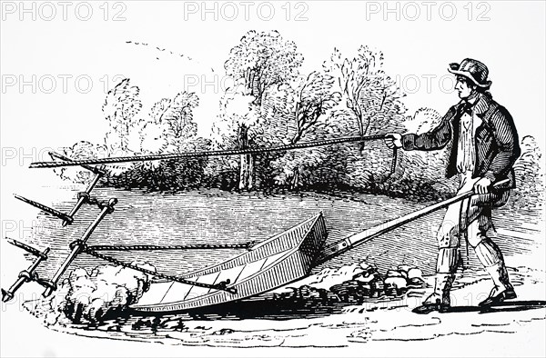 A farmer using a mollebart, or a levelling spade