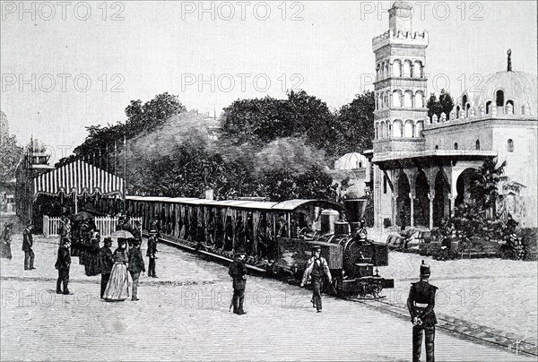 A Decauville locomotive carrying passengers in the Esplanade des Invalides, Paris