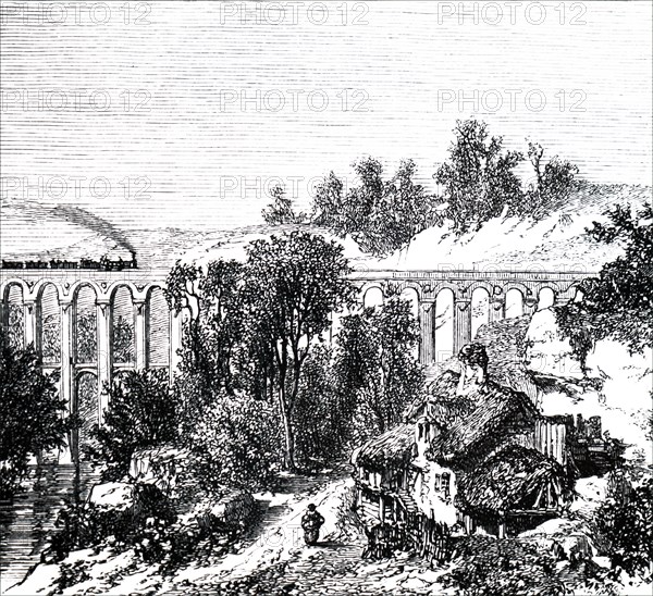 A train crossing viaduct near a remote farmstead