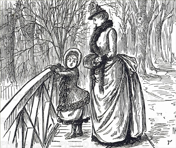 A mother and child viewing the Regent's Canal from a bridge in the park