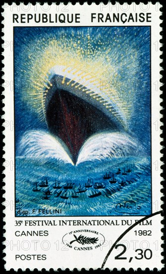 French postage stamp depicting the official poster of the 35th Cannes Film Festival, adapted from an original drawing by Italian film director Federico Fellini