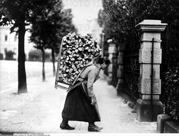 Woman delivering firewood, Munich,  1900