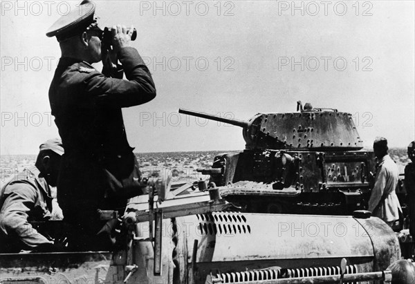 Rommel, Erwin 1891-1944
Officer, general field marshall, germany
commander of the german africa corps Feb.41-March 43 (WWII) 
Lt. gen. Rommel in his command post vehicle near Tobruk observing enemy positions. (r. an italian Carro Armato M13/40) 
14./15.Apr