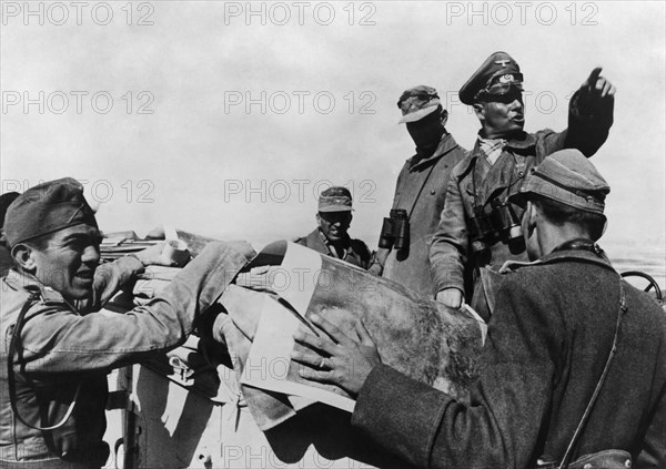 Rommel, Erwin 1891-1944
Officer, general field marshall, germany
commander of the german africa corps Feb.41-March 43 (WWII) 
during the second offensive to the Cyrenaika from end of
Jan. 1942 on: Col Gen. Rommel issuing commands from his command post vehi