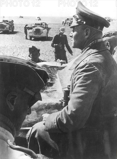 Rommel, Erwin 1891-1944
Officer, general field marshall, germany
commander of the german africa corps Feb.41-March 43 (WWII) 
Col.Gen. Rommel in his command post vehicle during the offenive May/June 1942: bypassing the Ghasala-line - south of Bir Hachheim.