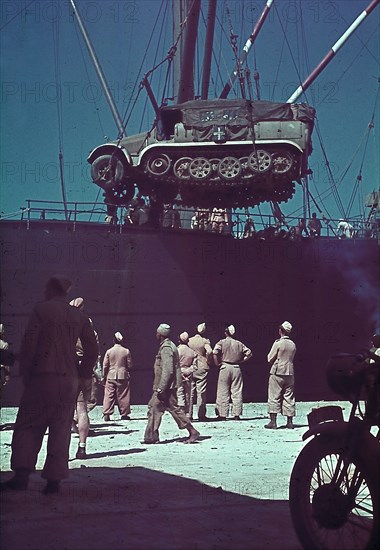 World War II North African Campaign: Unloading a half-track vehicle on a ship near Tripolis - summer 1941 - Photographer: Wolff & Tritschler - Vintage property of ullstein bild
