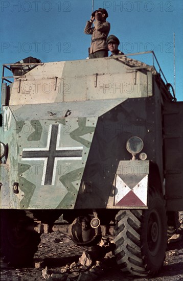 Field Marshal Erwin Rommel watching battlefield 1941 Tunisia in Captured British armoured truck MAX. MAMMUT