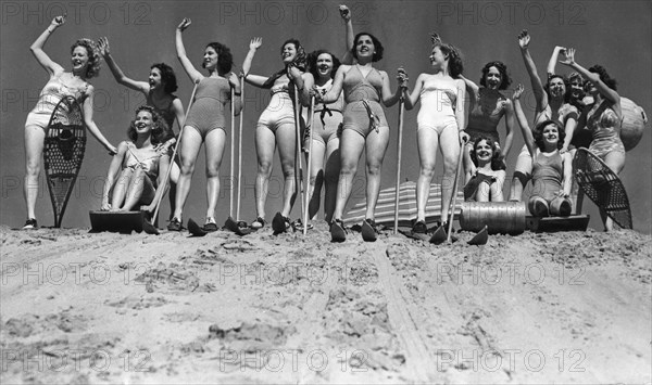 Women go skiing on a beach