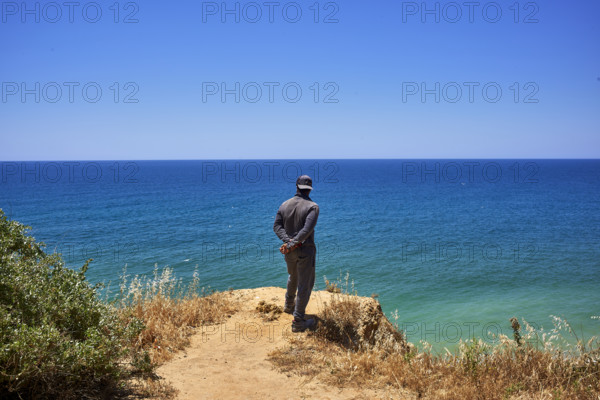 Un homme regarde la mer  en Algarve