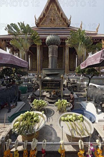 Sacrificial altar with lotus flowers in front of the Ubosot