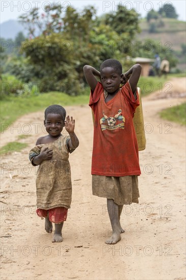 Two African children on a sandy track