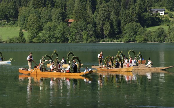 Men wearing traditional costumes in festively decorated squares