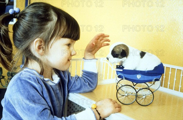 Girl playing with little puppy