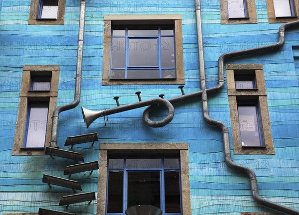 Blue house facade with rain pipes