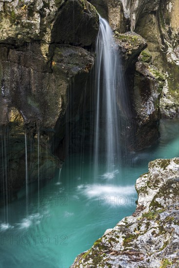 Emerald green wild river Soca flows through rocky gorge