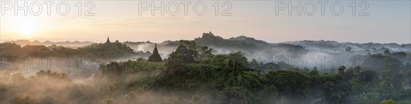 Mist over hills and stupas of Mrauk U at sunrise